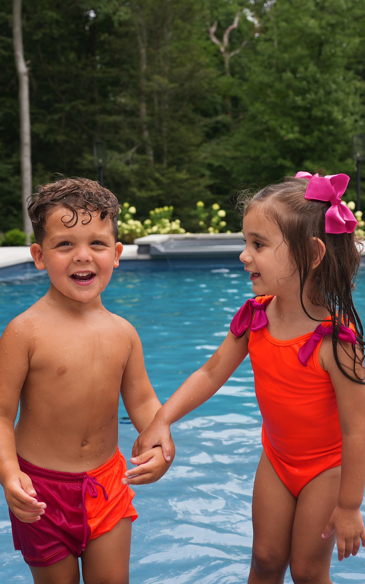 Minnie: Girl's Swimsuit in Neon Orange with Magenta Bows